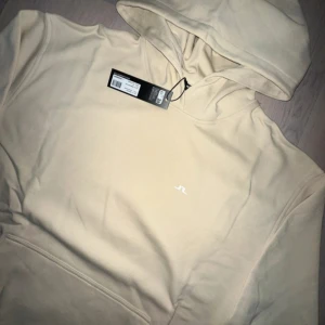 Beige hoodie från J.Lindeberg - Ny, storlek M