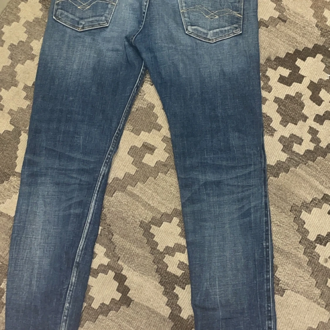 Blå jeans med slitningar