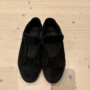 Svarta sneakers från Axel Arigato Strl 39 - Svarta sneakers från Axel Arigato i mocka. Strl 39. I använt skick 