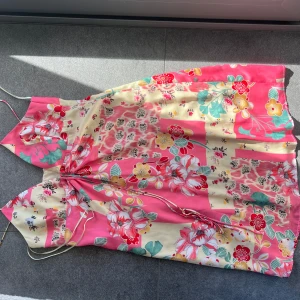 Kort zara klänning i rosa, grönt och beige - Säljer en färgglad klänning med blommigt mönster i rosa och beige.  Slutsåld på Zara sne några år tillbaka - aldrig använd på grund av för liten! 