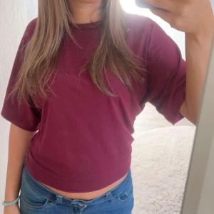 Vinröd oversized t-shirt - Enkel och stilren vinröd t-shirt med oversized passform och korta ärmar. Perfekt till jeans eller shorts för en avslappnad look.