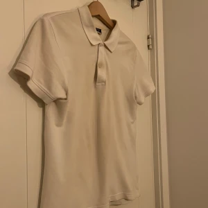 Vit pikétröja - Säljer en klassisk vit pikétröja med krage och knappar. Hör av dig vid funderingar!