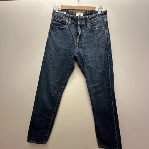 Jack and Jones jeans  - Snygga mörkblå jeans från Jack & Jones i loose fit-modell. Raka ben och normal midja. Jeansen är tillverkade i slitstarkt bomullsjeansmaterial och har en enkel, tidlös look som passar till det mesta. Storlek 29/32. Inga defekter. Mycket bra skick. 
