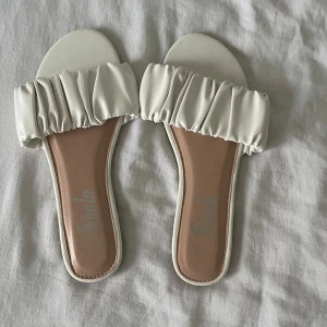 Vita sandaler från Shein - Snygga vita sandaler från Shein med rynkad detalj över foten. Perfekta för sommardagar och enkla att matcha med olika outfits.
