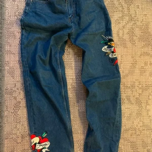 Ed Hardy-jeans,  ” True til Death”  storlek S - Low waist, perfekt passform på bakdel. Baggy 00-stil typ TLC. Sitter kvinnligt men löst, snyggaste jeansen men har växt ur dem! Broderi på ben och tryckt logga på bak. Lite slitna på ”häl” ser ändå bra ut. Inga andra fel. Snygga med både lösa t-hirts och korta toppar.Inköpta för 1600
