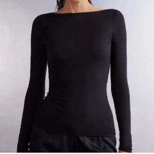 Intimissimi top - Snygg och stilren svart långärmad topp i tight passform. Perfekt för både vardag och fest. Tillverkad i ett mjukt och stretchigt material som sitter bekvämt på kroppen.