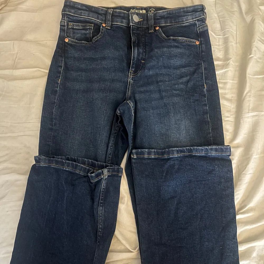 Säljer ett par snygga mörkblå hägmidjade jeans från Kappahl i storlek 40. De har en klassisk femficksdesign och är tillverkade i hållbart denimtyg. Lite liten i strl och väl använda men bra skick.. Jeans & Byxor.