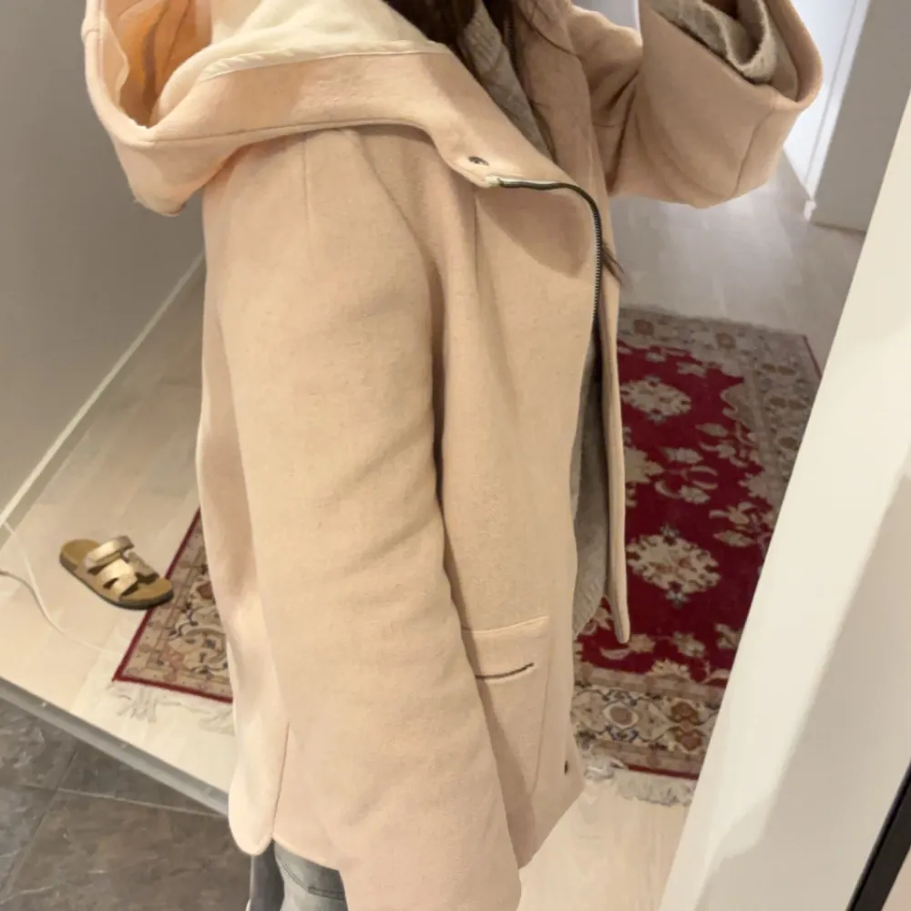 Säljer en superfin beige kappa med huva. Perfekt för höst och vår! Den har en stilren design med knappar framtill och praktiska fickor. Jackan är i  bra skick och passar perfekt för en chic vardagslook. Pris kan diskuteras. Jackor.