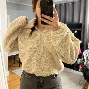 Teddy tröja - Teddy tröja med halv zip, finns så man kan dra åt i midjan.