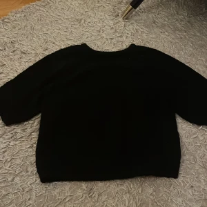 Svart tröja  - Säljer en stilren svart tröja från Lindex i storlek S. Perfekt för både vardag och festliga tillfällen. Tröjan har en klassisk design med normal passform och trekvartsärmar. Ett måste i garderoben för alla säsonger!