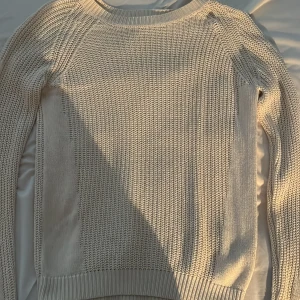 Beige stickad tröja från VILA - Säljer en stilren beige stickad tröja från VILA. Perfekt för kyliga dagar med sin mjuka och bekväma passform. Tröjan har långa ärmar och en rund halsringning.