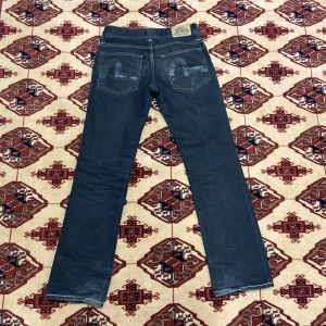 Evisu Puma - Ett par Evisu Puma. Lite slitna som man kan se på bilderna men inga hål. Kan skickas mer inzoomade bilder på detaljer. Mörk blåa jeans. Midja 39-40 cm. Ytterben 102-3 cm. Innerben 78-9 cm. Benöppning 20 cm. 