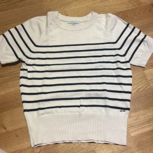 Holly & Whyte tröja - Säljer en vit tröja med marinblå ränder från Holly & Whyte by Lindex. Tröjan är använd fåtal gånger men fortfarande i bra skick utan några defekter 