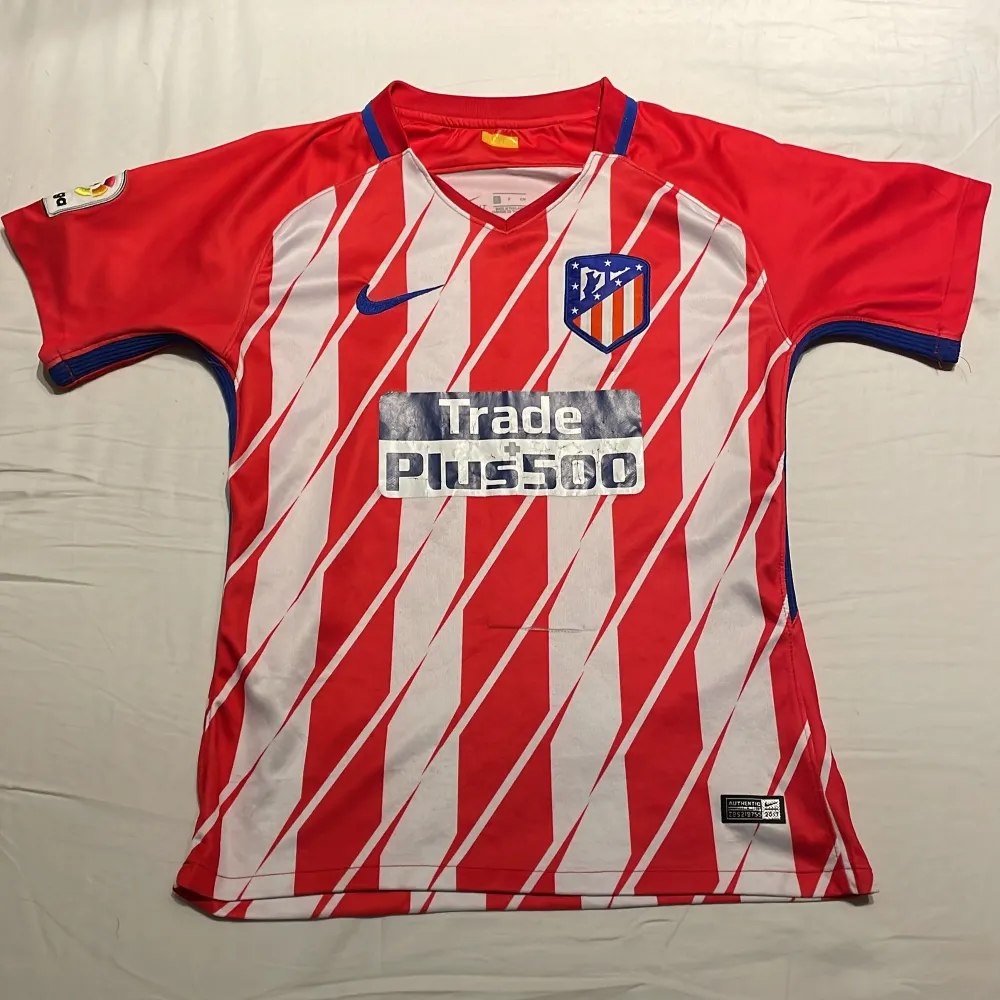 Säljer denna Atletico Madrid tröja från 2017. Min pappa köpte den till mig på arenan så den är äkta men den är lite sliten därav priset. Har varit Griezmann på ryggen men det har lossnat. Litet slitage på magen. Kom gärna med prisförslag och frågor.. Sportswear.