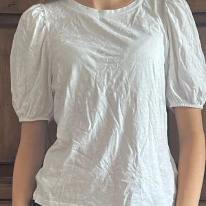 T-shirt  - En fin vit t-shirt med puff armar. Den är lite skrynklig men går lätt att stryka den. Varan har andvänds ett par gånger men är i bra skick. Hör av er om ni har fler frågor 🥰😗 