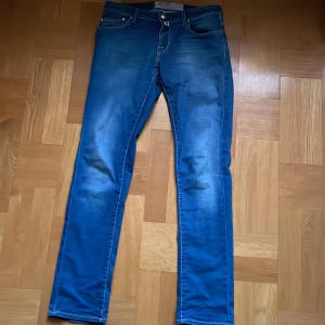 Cohën Jeans - Jeans från Jacob Cohën, Tailor Made. Inga andra defekter än 2 slitningar, en på baksidan av byxan runt vaden och en på framsidan. Hör av er om ni undrar mer. Priset är ej hugget i sten!