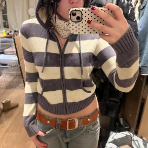 Randig brandy melville zipup - Säljer en randig brandy melville hoodie i djuplila och vitt med dragkedja framtill. Tröjan har långa ärmar och en huva med snören. Köpt för 300ish o säljer nu för bara 130! 