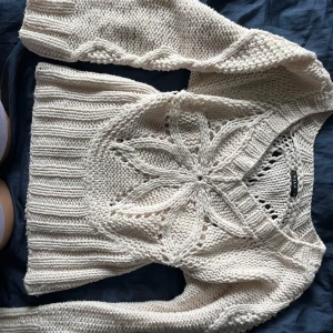 Tjocktöja med hål (blomma form) - Vila stickad tjocktröja