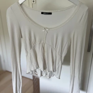 Gina Tricot tröja - Säljer denna trendiga tröja från Gina Tricot med snitt vid framsidan och detaljer vid bysten då den är lite för liten för mig. Storlek S och är i bra skick!⚪️🥥🫶🏽 Mitt sista pris🩷