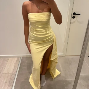 Bal klänning - En superfin gul bal klänning ifrån babyboofashion. Jag har aldrig använt klänningen och prislappen sitter kvar. Skriv för bilder på prislapp och kvitto. Den har rynkningar upptill och är ”övervikt” vid brösten. Storlek S, klänningen är stretch material. 