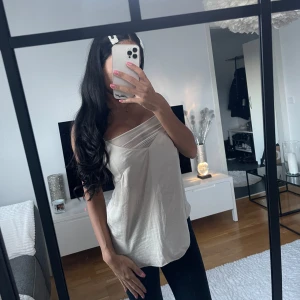 Beige ärmlös linnetopp - Säljer en stilren och enkel beige linnetopp.