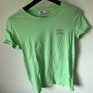 Neongrön t-shirt - Neongrön t-shirt med text på bröstet från NewYorker. Storlek xxs, men ganska stor i storleken så funkar som en XS eller till och med S. Använd någon gång, därmed bra skick. 