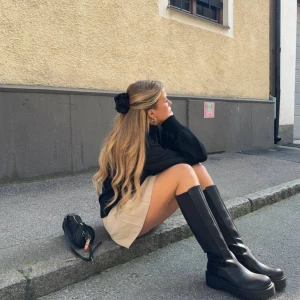 Svarta stövlar i skinn - Snygga svarta stövlar i skinn med en stilren design. Perfekta för höst och vinter, dessa stövlar har en klassisk look som passar till många olika outfits. De är bekväma och ger ett elegant intryck.