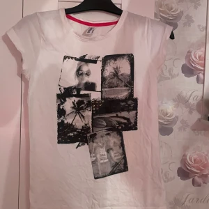 Vit t-shirt  - Vit t-shirt med olika bilder där fram på tröjan