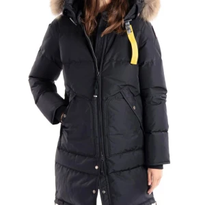 Parajumper vinterjacka - Snygg och varm svart dunjacka från Parajumpers med pälsdetaljer på huvan. Modellen är longbear och är i storlek XS men passar S. Jackan har en dragkedja och knappar framtill samt praktiska fickor. Perfekt för kalla vinterdagar. Endast använt en vinter. Behöver sälja akut!!