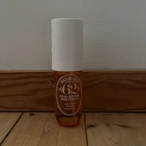 Brazilian Crush Cheirosa 62 - En doftspray med en härlig blandning av pistage och saltad karamell. Flaskan är bärnstensfärgad med en vit spraykork och ett avtagbart lock med elegant mönster. Perfekt för att ge en exotisk touch till din dag. Cirka 4/5 kvar, skriv vid fler frågor!