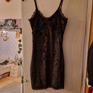 Klänning - Kort, tight klänning i ett sammets liknande material, axelbanden är justerbara, Begagnat men bra skick.