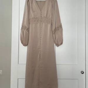 Långklänning  - Super fin lång klänning. Helt oanvänd. Lång och lite utsväng i armarna, stretchiga men tajt passform längst kroppen. Köptes för 800 och har aldrig använts. 