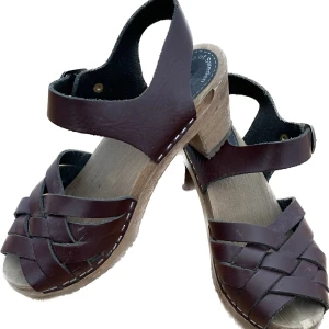Sandaler - Träskor/sandaler från Olivia of Sweden i vinrött läder. Finns en liten skada i träet vid ena tån, annars i gott skick. Säljer pga lite för små för mig:((