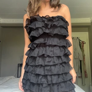 Festklänning  - Superfin svart festklänning med volanger. Perfekt till fest