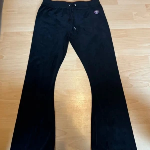 Black Juicy Couture Pants  - I wore these once and never again the logo on one of the strings has fallen off I bought this with the original price at 1300 so I took 200 of because of that the size is a XL I want to sell as soon as possible so text me if you are interested please