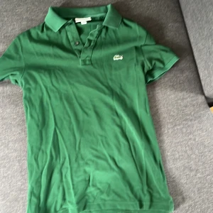 Lacoste piké  - Använd men i bra skick. Grön, storlek S slim fit.