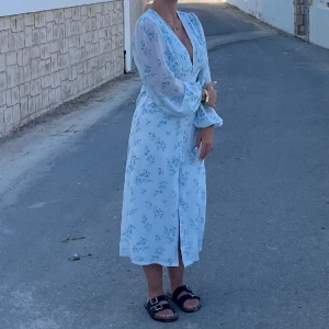 Super fin lång klänning  - Jätte fin vit klänning med blåa blommor på! Perfekt till sommaren. 