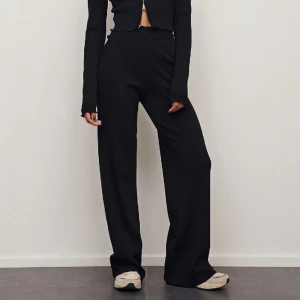 Svarta ribbstickade byxor - Fina svarta högmidade byxor. Använda fåtal gånger. Köpta för 419 kr.