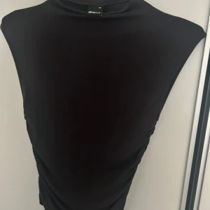 En mörkgrå topp.  - En mörkgrå topp från Gina Tricot i storlek Xs. 