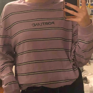  - en lila tröja köpt på urban outfitters herr avdelning med texten ”portland”
