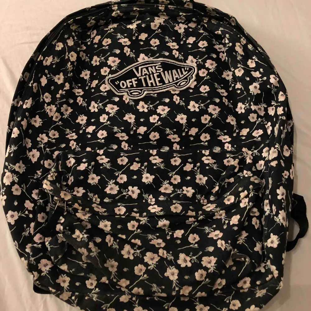 En fin vans ryggsäck som är svart med ett blommigt mönster i tyg! Finns ett stort fack och ett mindre! Justerbara axelband, den är i fint skick och sparsamt använd. Väskor.