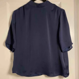  - Marinblå blus. Aldrig använd, lapp sitter kvar. Köpare står för frakt. 