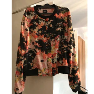  - Blommig tunn bomberjacka från Asos. Strl 40.  Möts i Stockholm eller skickar mot att köparen betalar frakten. 