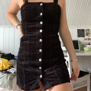 Klänning - Svart manchesterklänning med knappar🖤 den här är använd endast några få gånger men väldigt fin! Det är som sagt manchester tyg med justerbara axelband och knäppning hela vägen!!