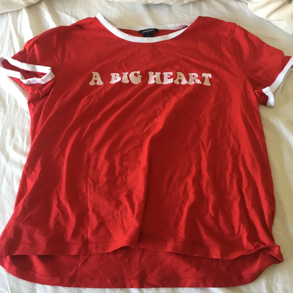 En skön röd T-shirt med texten ”A big heart” i lite av en 60/70-tals font. Använd väldigt få gånger, storleken är L men jag som är S passar i den ändå. Frakt: 22 kr. T-shirts.