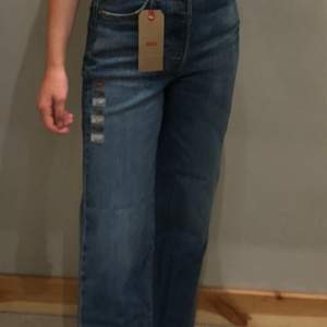 Säljer ett par mörkblåa ribcage straight jeans från levis. De är i storlek 25 och på mig som är 157 cm sitter de ner till fötterna medan de är lite kortare på modellen på bilden✨ kontakta mig för fler bilder