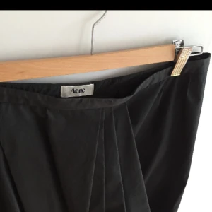  - Asymmetrisk, stilren kjol från Acne i storlek 38.  Använd endast ett fåtal gånger. Nyskick. Säljes pga flytt. 