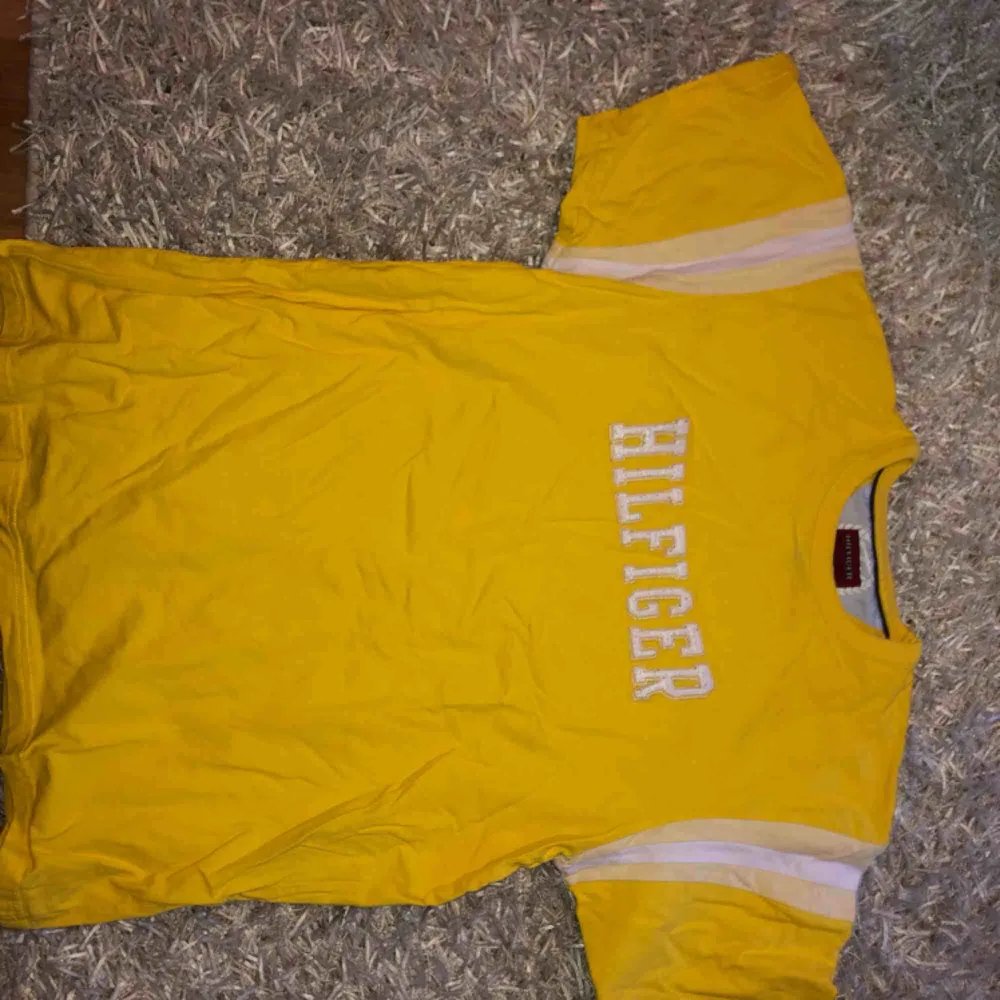 Cool gul Hilfiger tröja storlek M men passar S. Retro och jättebra skick!! . T-shirts.