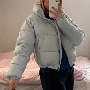 Ljusblå pufferjacket stl M - Jättefin ljusblå pufferjacket från pull&bear! Den är i storlek M men passar bra för mindre storlekar också. Det går att justera i midjan (längst ner på jackan) Använd några gånger men den är inte sliter eller fläckig alls! 