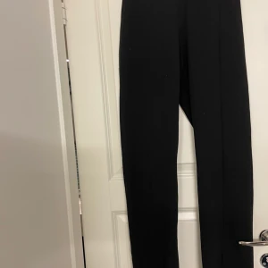 Byxor med slits från nelly - Svart kostymbyxa ifrån nelly med slits
